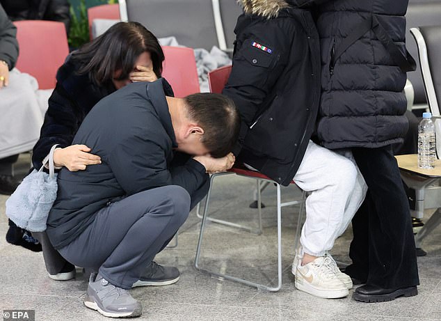 Family members of a victim of the Jeju Air plane crash grieve at Muan International Airport in Muan, South Jeolla Province, South Korea, on December 29