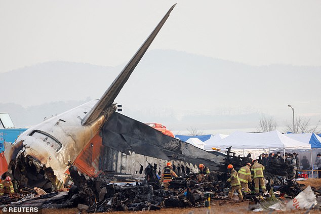 Emergency workers inspect the wreckage of Jeju Air Flight 2216