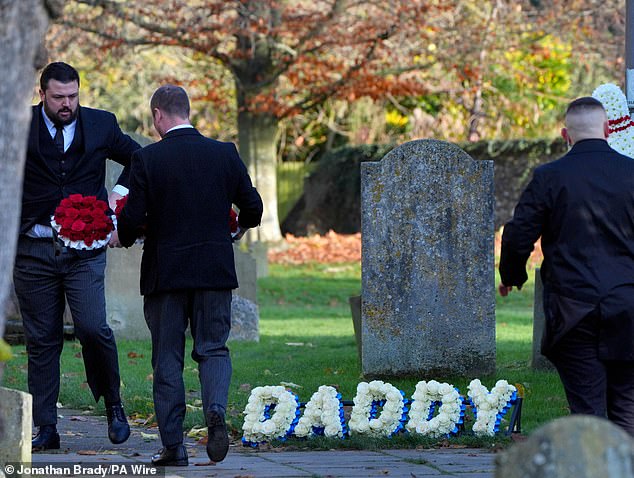 Funeral directors place a floral tribute which says "Daddy" outside the funeral service of One Direction singer Liam Payne