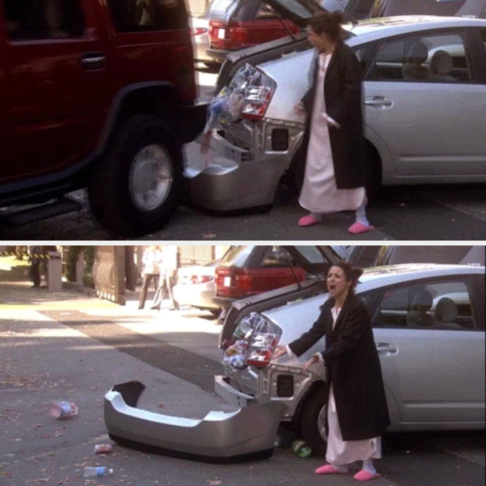 A person in a bathrobe and slippers reacts to a rear-end car collision, showing a car’s damaged bumper and scattered trash on the street