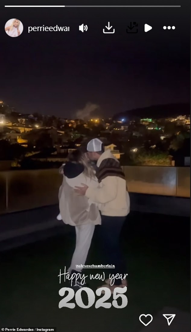 Perrie Edwards rang in the new year by sharing a sweet kiss with fiancé Alex Oxlade-Chamberlain and their son Axel as they watched fireworks on a rooftop