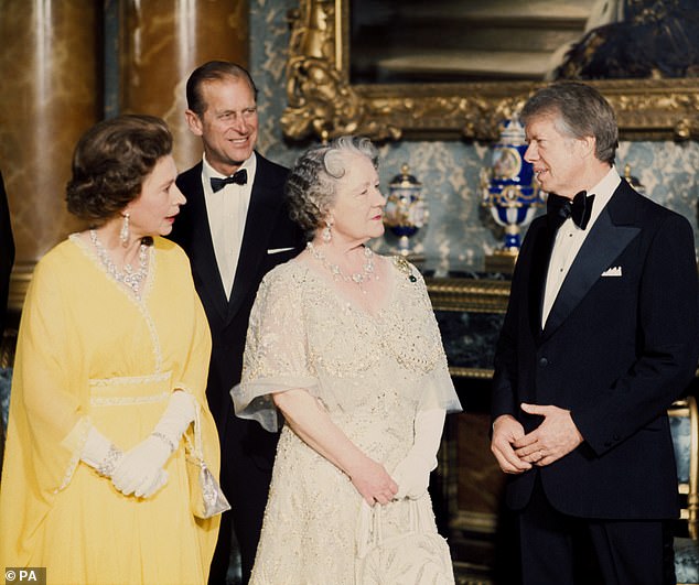 President Jimmy Carter is seen speaking with Her Majesties The Queen and the Queen Mother, as Prince Philip stands in the background, in the Blue Drawing Room at Buckingham Palace during a visit in May 1977