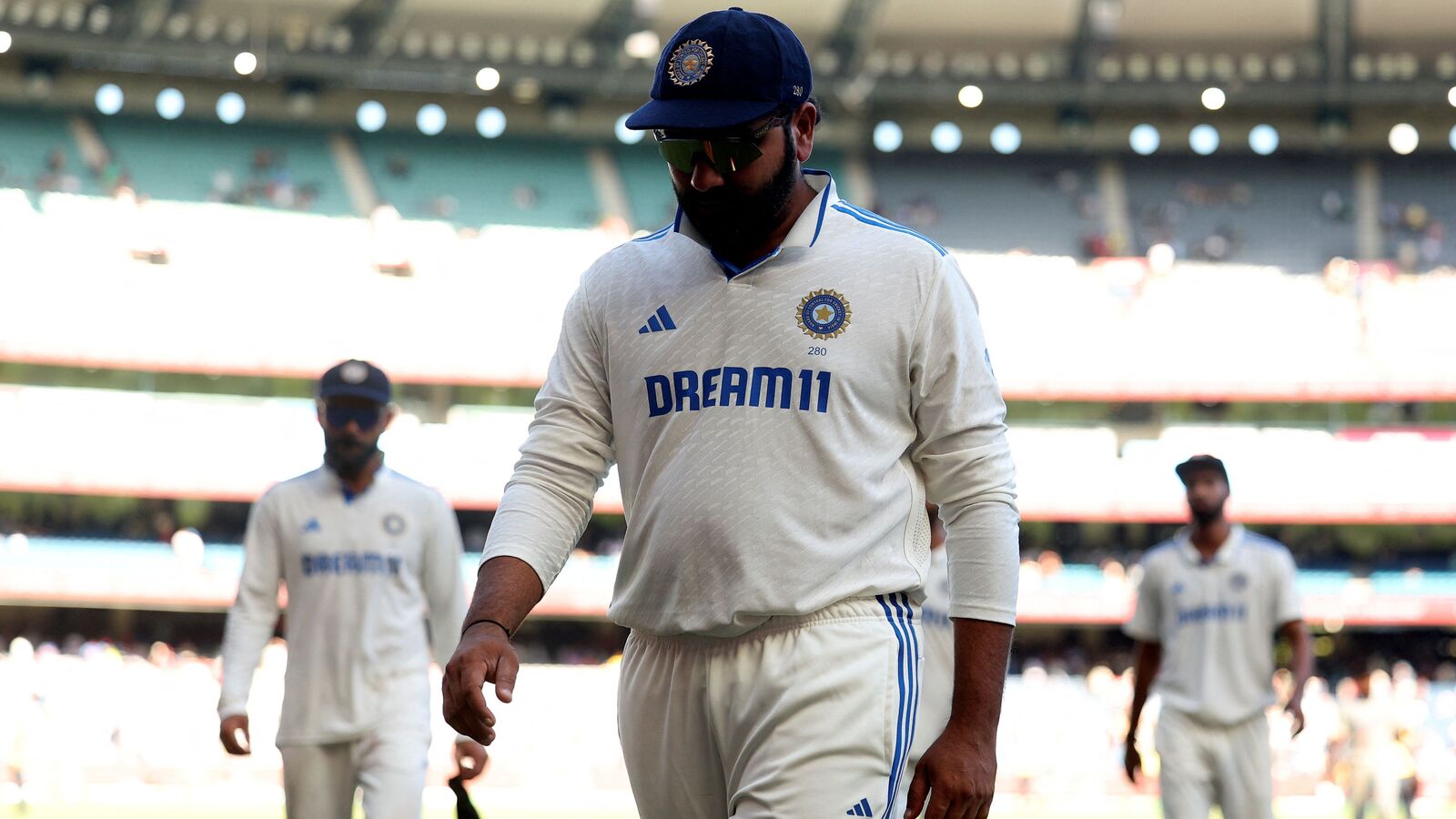 India's Rohit Sharma leaves the field at the close of play on day four of the fourth cricket Test match between Australia and India at the Melbourne Cricket Ground (MCG) in Melbourne on December 29, 2024. (Photo by Martin KEEP / AFP)