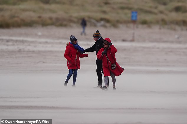 Sand is whipped up by the wind on Tynemouth Longsands beach in North Tyneside today