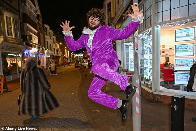 WEYMOUTH: New Years Eve reveller wearing Austin Powers fancy dress out in the town at Weymouth in Dorset for the New Year celebrations