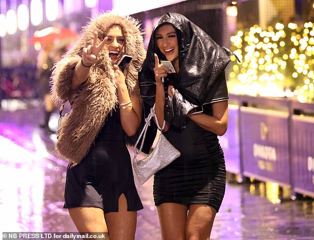 LEEDS: These two revellers in Leeds smiled despite being soaked by the rain