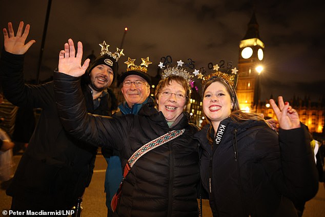 LONDON: Revellers gather in Parliament Square in central London before New Year's Eve fireworks illuminate the night sky