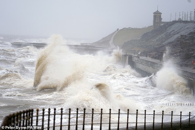 Waves hit Blackpool seafront in Lancashire today as snow, rain and wind warnings are in force