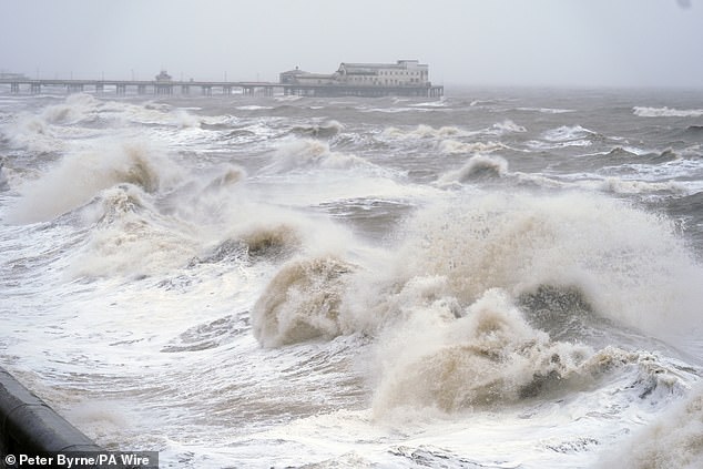 Waves hit Blackpool seafront in Lancashire today as snow, rain and wind warnings are in force