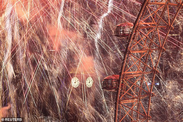 Fireworks explode in a dazzling display over Big Ben and the London Eye