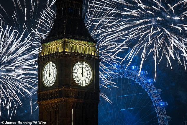 Fireworks light up the sky over Elizabeth Tower, also known as Big Ben, and the London Eye in central London during the New Year celebrations