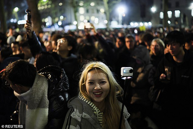 People wait for fireworks on New Year's Eve, in London, Britain, December 31, 2024