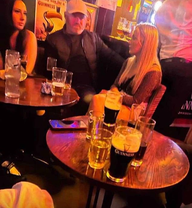 Rooney seen sitting with a group of women during a night out in a pub