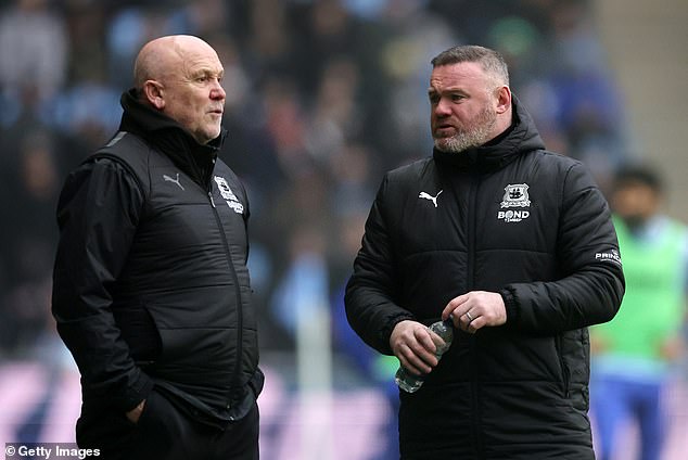 Mike Phelan, left, recently joined as Rooney's assistant in a bid to turn around the club's form