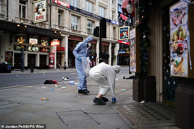 Forensic investigators collect evidence at the scene on Shaftesbury Avenue on Christmas Day