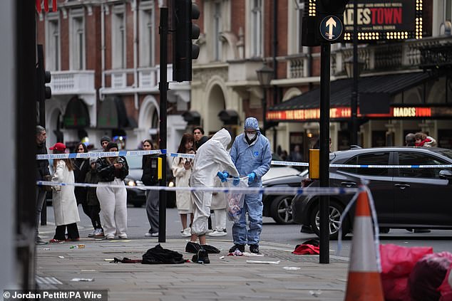 Forensic investigators collect evidence at the scene on Shaftesbury Avenue on Christmas Day