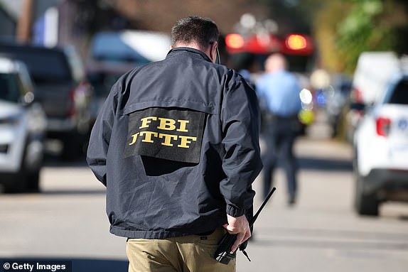 NEW ORLEANS, LOUISIANA - JANUARY 01: FBI agent on the scene outside a house fire on Mandeville Street that may be connected to the mass casualty Bourbon Street attack where at least ten people were killed when a person allegedly drove into the crowd in the early morning hours of New Year's Day on January 1, 2025 in New Orleans, Louisiana. Dozens more were injured after a suspect in a rented pickup truck allegedly drove around barricades and through a crowd of New Year's revelers on Bourbon Street. The suspect then got out of the car, opened fire on police officers, and was subsequently killed by law enforcement. (Photo by Chris Graythen/Getty Images)