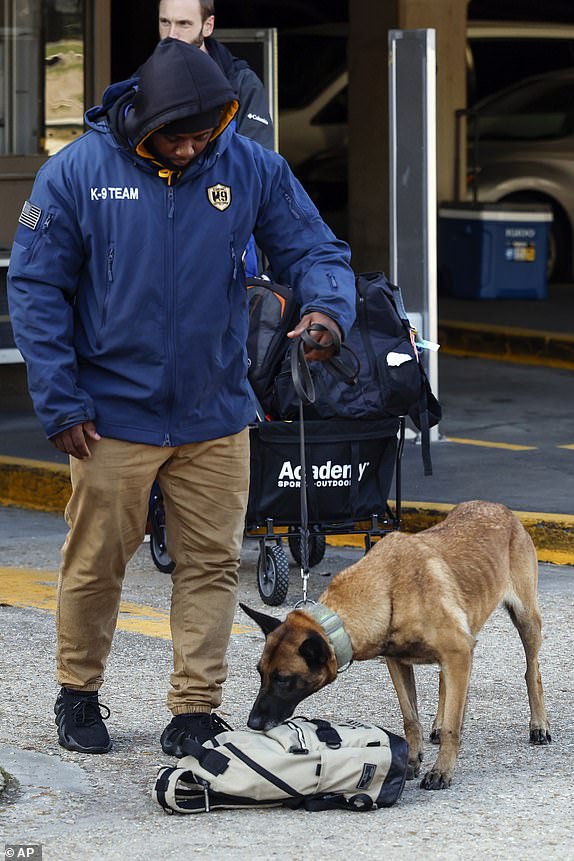 Security and bomb sniffing dogs check backpacks before entering the Superdome ahead of the Sugar Bowl NCAA College Football Playoff game, Thursday, Jan. 2, 2025, in New Orleans. (AP Photo/Butch Dill)