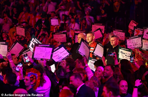 Darts - 2025 PDC World Darts Championship - Alexandra Palace, London, Britain - January 1, 2025 Nathan Aspinall during his walk on before his quarter final match against Luke Littler Action Images via Reuters/Andrew Boyers