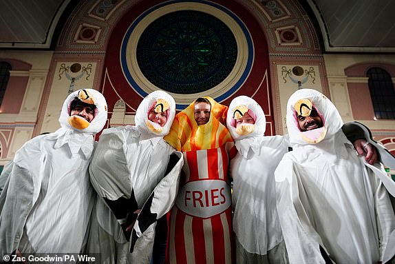 Darts fans in fancy dress during day fifteen of the Paddy Power World Darts Championship at Alexandra Palace, London. Picture date: Thursday January 2, 2025. PA Photo. See PA story DARTS World. Photo credit should read: Zac Goodwin/PA Wire.RESTRICTIONS: Use subject to restrictions. Editorial use only, no commercial use without prior consent from rights holder.