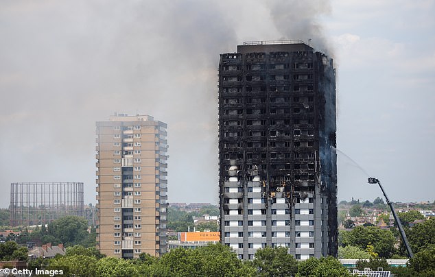 A minister yesterday admitted the Government must 'seriously look' at the impact toxic smoke had on those who fought the 2017 blaze. Pictured: Grenfell Tower block in Latimer Road, West London