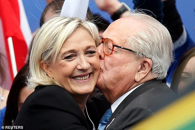 Jean-Marie Le Pen, France's National Front political party founder, embraces his daughter Marine Le Pen, who succeeded him as the party's leader