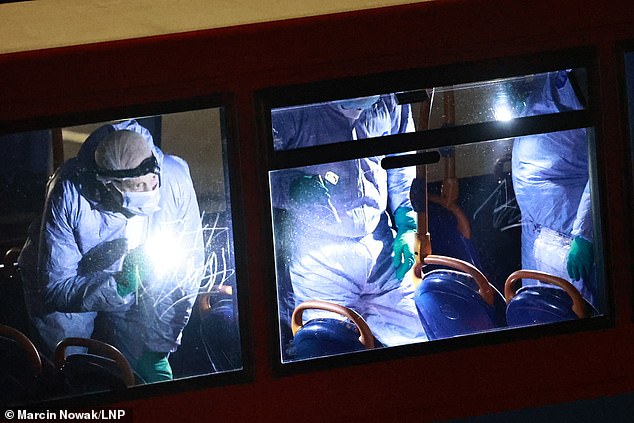 Forensic officers were seen on board the double decker bus shining torches and gathering evidence on Tuesday