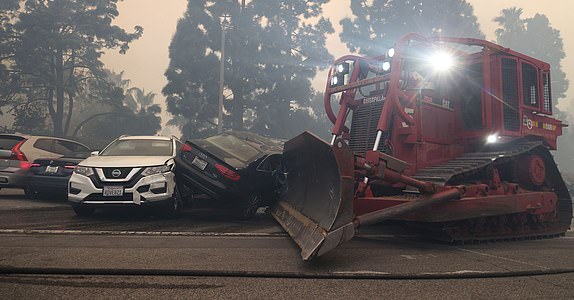 Mandatory Credit: Photo by Jonathan Alcorn/ZUMA Press Wire/Shutterstock (15083449e) A fire department bulldozer moves abandoned cars which blocked Sunset Blvd. California Wildfires 2025: Pacific Palisades, Los Angeles, USA - 07 Jan 2025