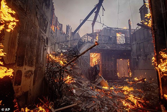 The Palisades Fire burns a residence in the Pacific Palisades neighborhood of Los Angeles, Tuesday, Jan. 7, 2025. (AP Photo/Etienne Laurent)