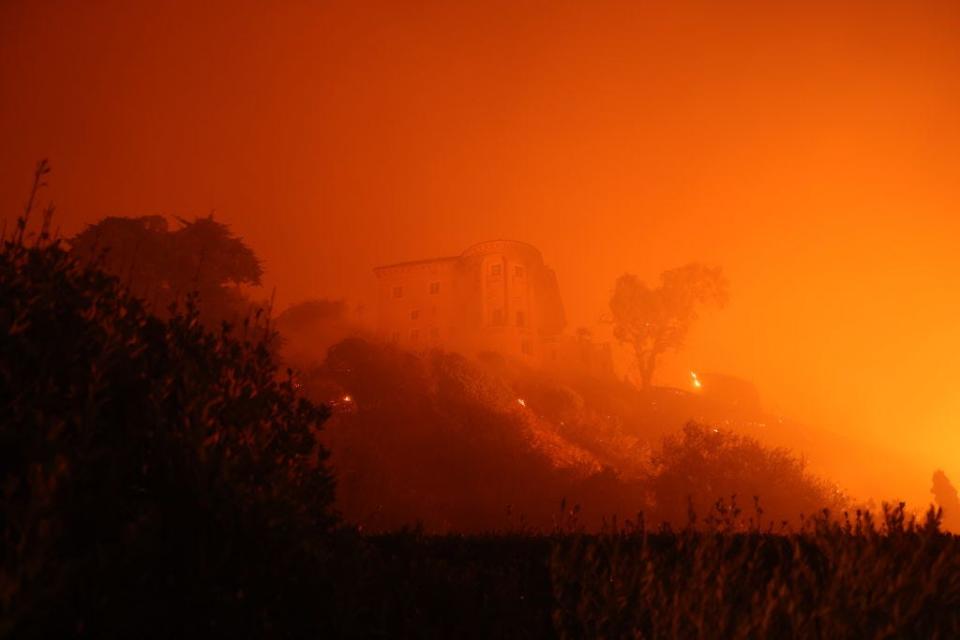 The Villa de Leon, known as the Kauffman Estate, engulfed in smoke during fires in California.