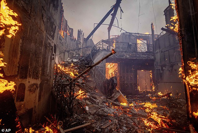 A large house in the Pacific Palisades neighbourhood of Los Angeles is engulfed in flames