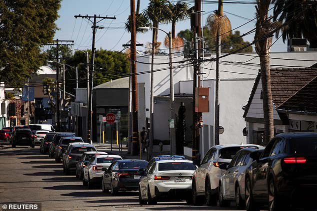 Cars line up as people evacuate due to a wildfire near Pacific Palisades, on the west side of Los Angeles