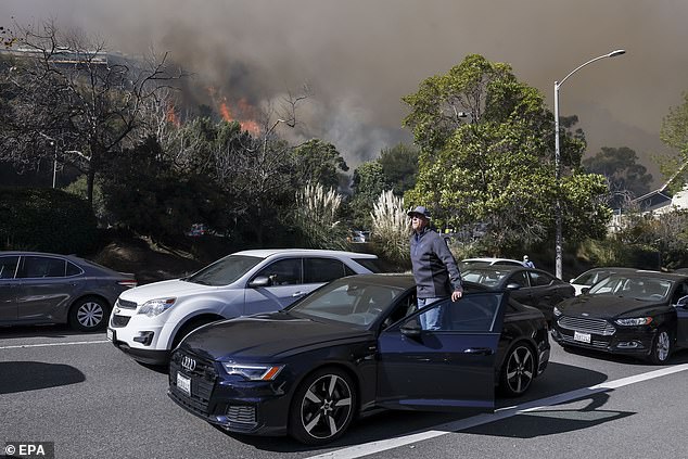 People stuck in a gridlock traffic as they try to evacuate a neighborhood being threatened by the Palisades wildfire