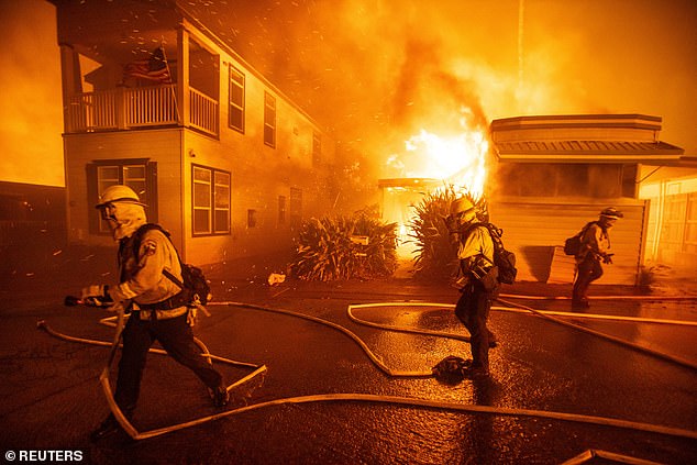 Firefighters battle the Palisades Fire as it burns during a windstorm on the west side of Los Angeles