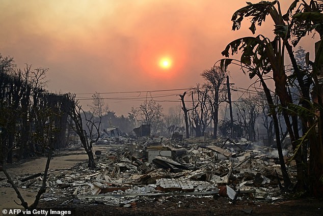 The apocalyptic scene as smoke rises over buildings burned to the ground by the Palisades Fire in California