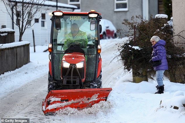 SCOTLAND: A snow plough clears snow following the coldest night of winter so far in Breamar, Scotland