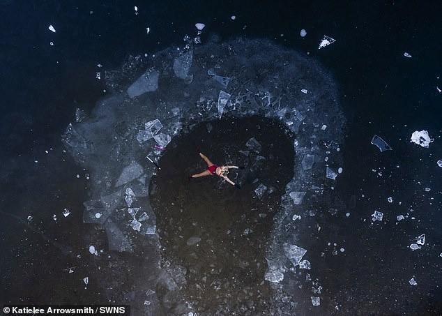 WEST LOTHIAN: A wild swimmer braves the freezing waters of Avon Lagoon in West Lothian, amid a sea of ice on Friday