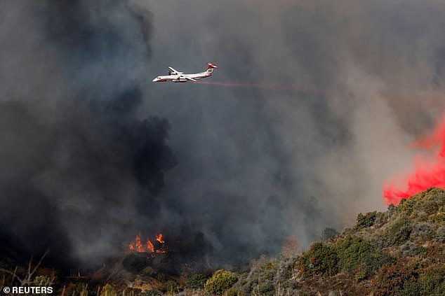 Firefighters and helicopters have also been seen circling the area and making massive water drops as the 22,660-acre fire continues to spread.