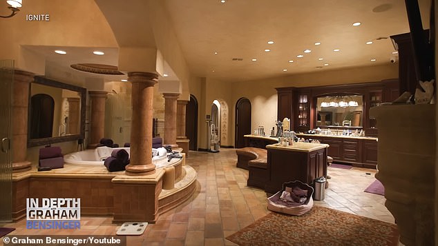 One of the massive bathrooms is seen here with an enormous hot tub and even a seating area