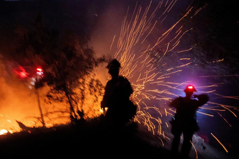 The wind whips embers while firefighters battle the fire in the Angeles National Forest near Mt. Wilson (REUTERS)