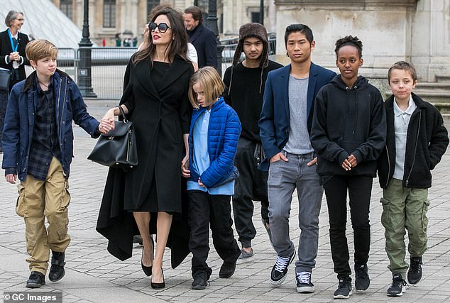 The former couple conceived three children - Shiloh, 18, and twins Knox and Vivienne, 16 - and also adopted Maddox, 23, Pax, 21, and Zahara, 19 (Jolie seen with all six kids in 2018 in Paris)