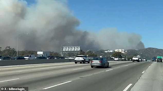 Footage from earlier today shows at least one house ablaze in the canyon and massive clouds of smoke billowing near Sepulveda Pass at Highway 405