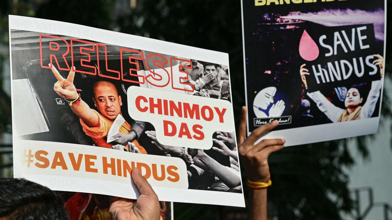 Devotees and members of the International Society for Krishna Consciousness (ISKCON) hold posters during a protest outside the Bangladesh High Commission in Mumbai on December 2, 2024, amid the unrest in Bangladesh after the arrest of Hindu monk Chinmoy Krishna Das Brahmachari. (Photo by Indranil MUKHERJEE / AFP)