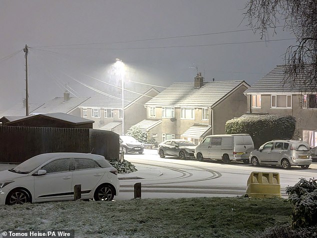 Snow falling in Newport. Large parts of the country will face disruption from heavy snow and freezing rain over the weekend after forecasters issued two amber weather warnings