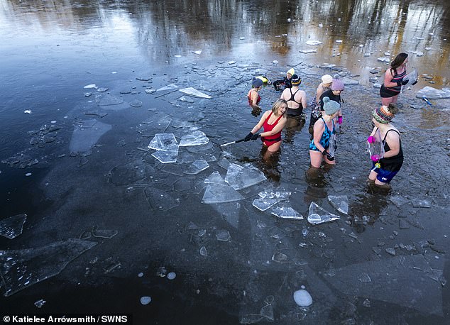 WEST LOTHIAN: Wild swimmers break ice covering the Avon Lagoon in West Lothian as they prepare for a swim on Friday