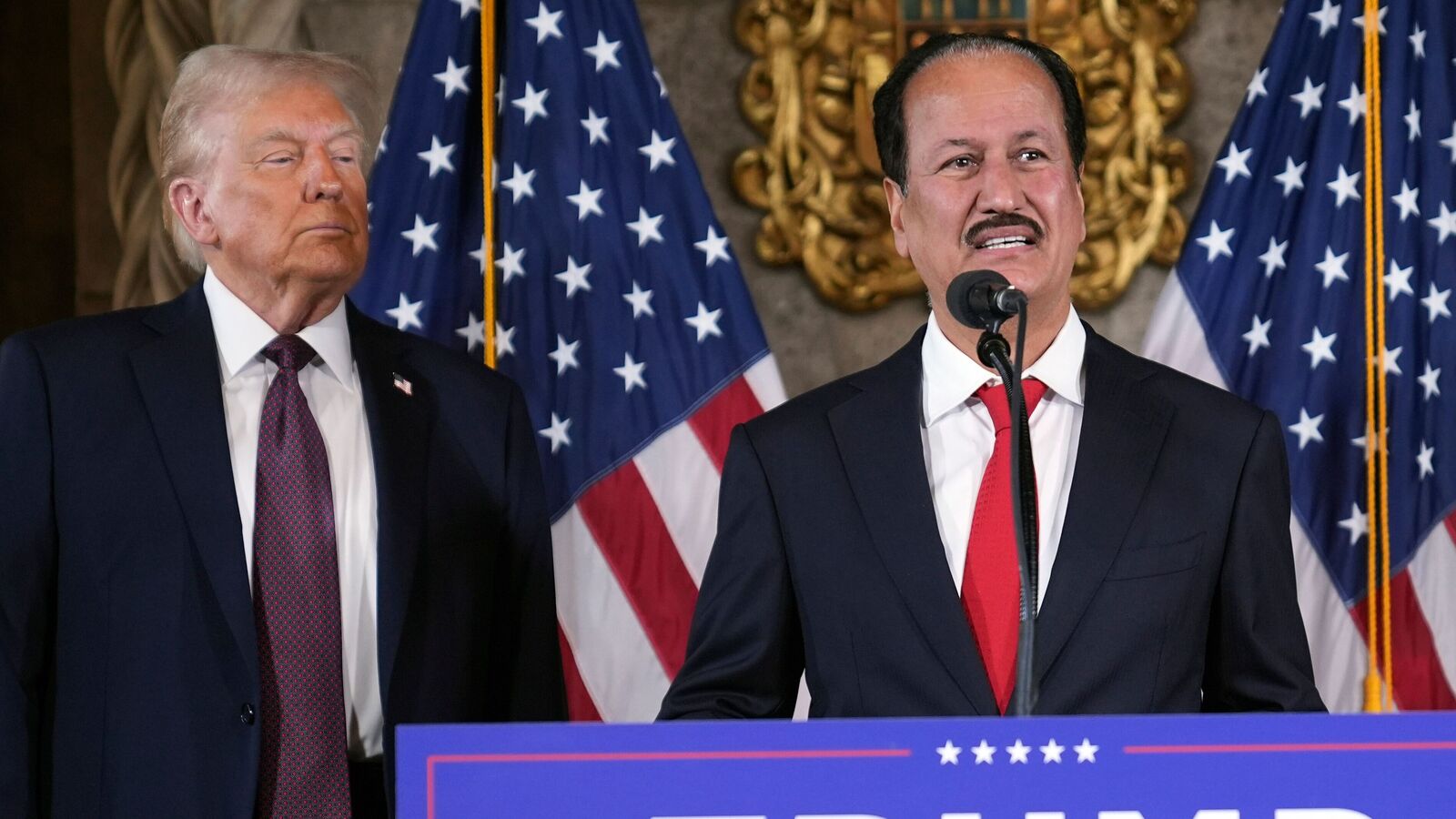 President-elect Donald Trump listens as Hussain Sajwani, CEO of DAMAC Properties, speaks during a news conference at Mar-a-Lago, Tuesday, Jan. 7, 2024, in Palm Beach, Fla. (AP Photo/Evan Vucci)