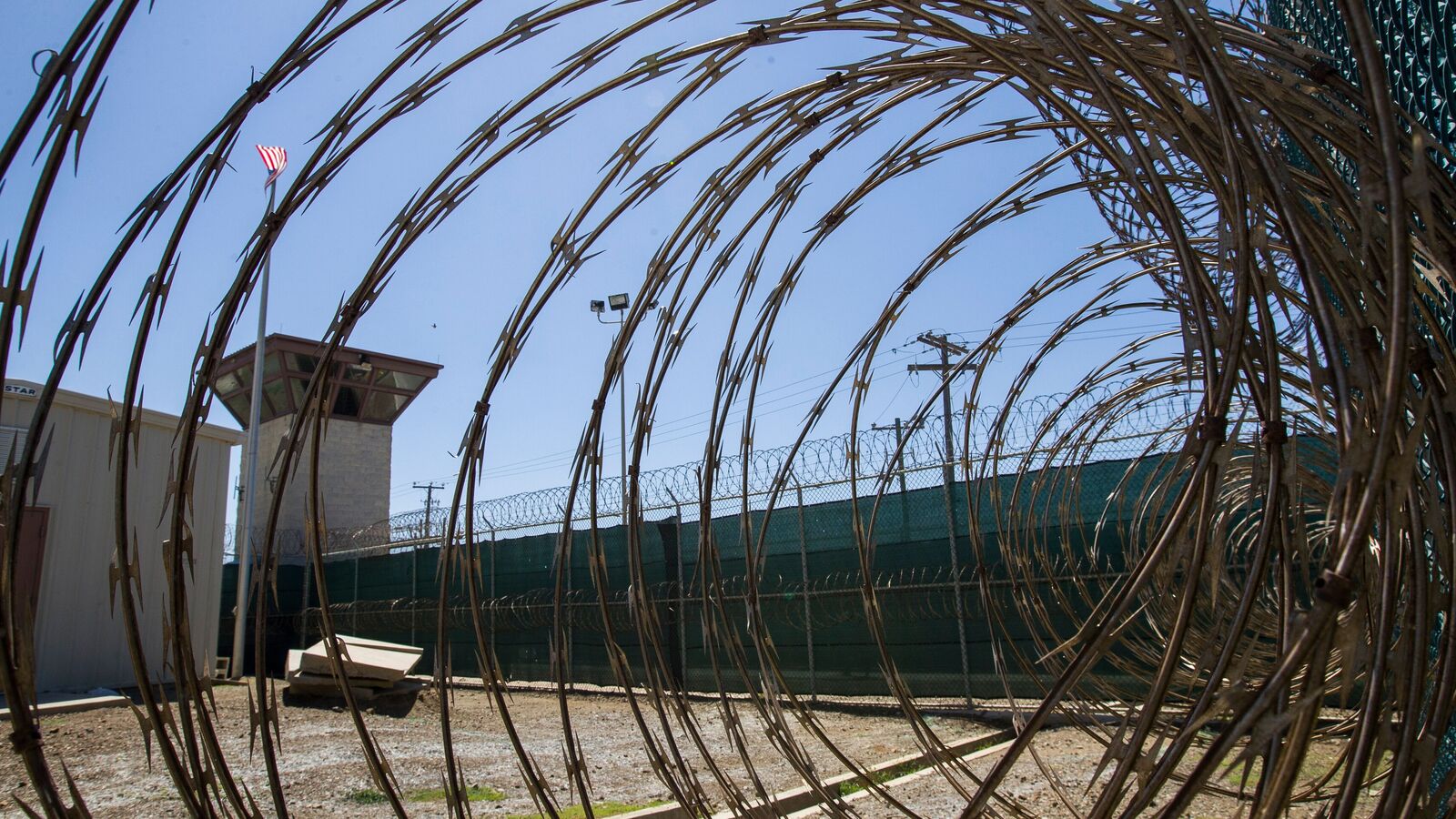 In this April 17, 2019, photo, reviewed by U.S. military officials, the control tower is seen through the razor wire inside the Camp VI detention facility in Guantanamo Bay Naval Base, Cuba. (AP Photo/Alex Brandon, File)