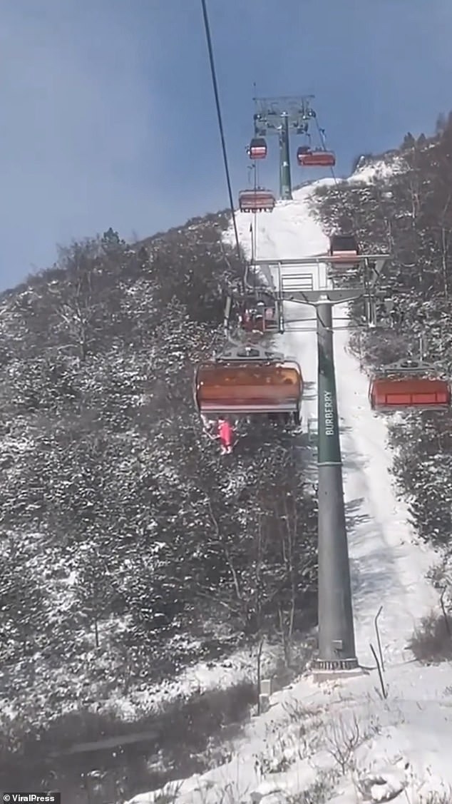 Holidaymakers spotted the youngster dangling from an ascending cable car chair at Genting Resort Secret Garden in Zhangjiakou, Hebei