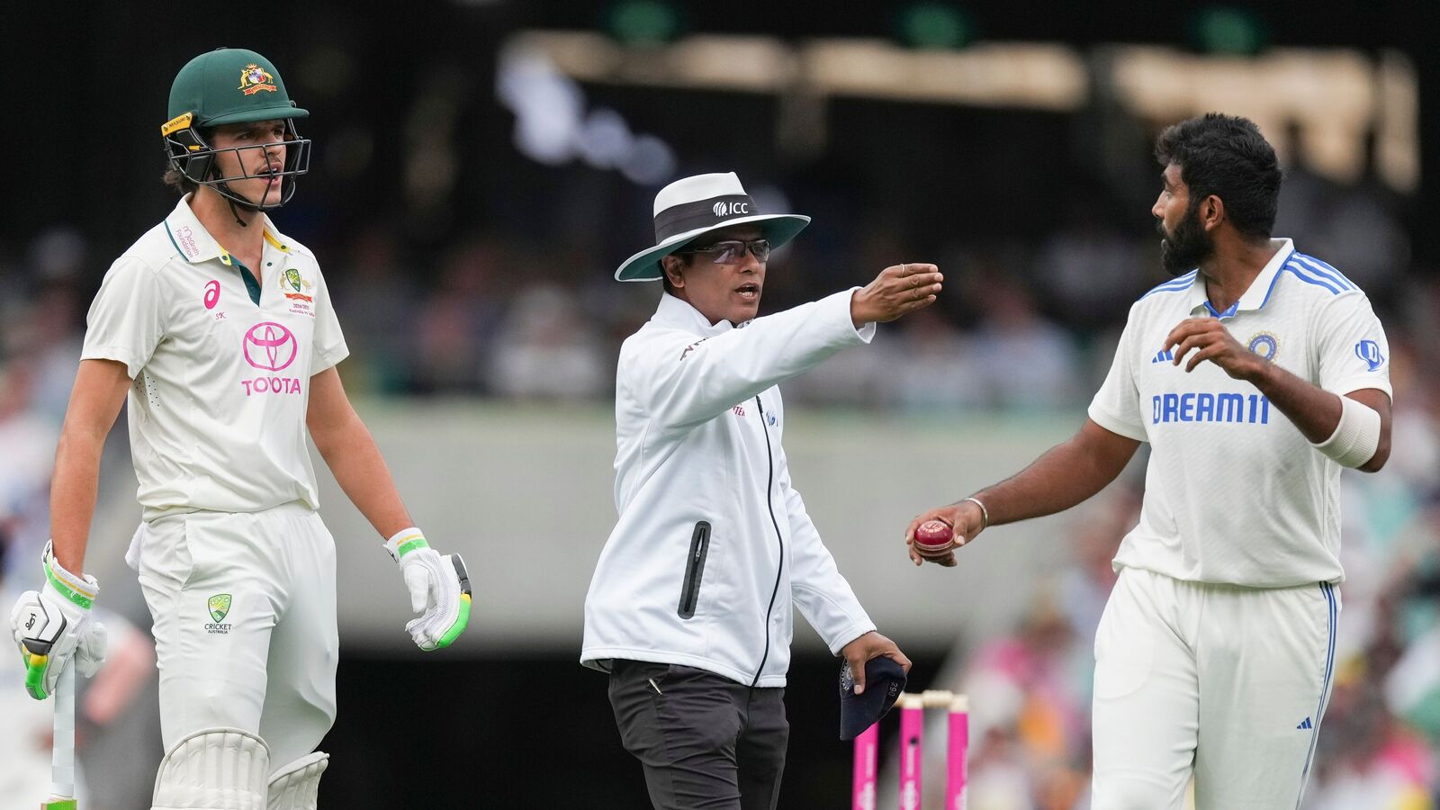 Umpire Sharfuddoula Saikat, centre, gestures to India's Jasprit Bumrah, right, as he exchanges words with Australia's Sam Konstas, left, during play on the first day of the fifth cricket test between India and Australia at the Sydney Cricket Ground, in Sydney, Australia, Friday, Jan. 3, 2025. (AP Photo/Mark Baker)