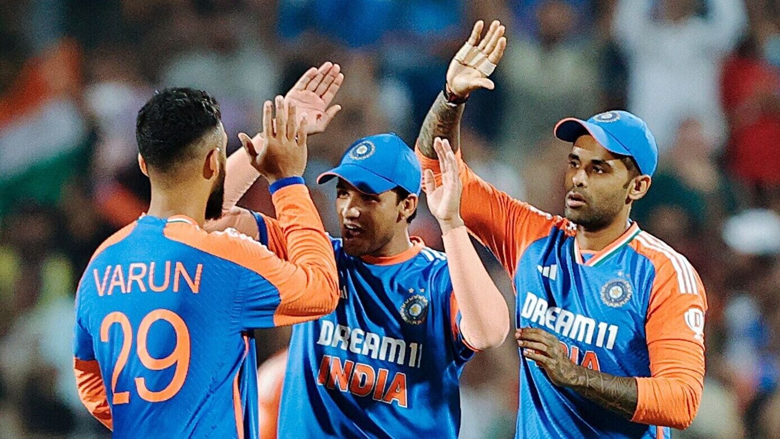 India's Varun Chakravarthy, Abhishek Sharma and captain Suryakumar Yadav celebrate the dismissal of England's Harry Brook in the 4th T20I..